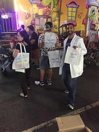 Doctor Signh handing out swag bags at a community event