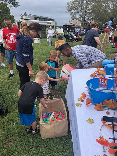 Kids choosing game prizes at a community event