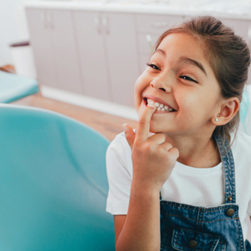 Young smiling girl at dentist