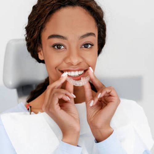 Close up of woman inserting clear aligner