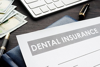 Dental insurance form on wooden desk