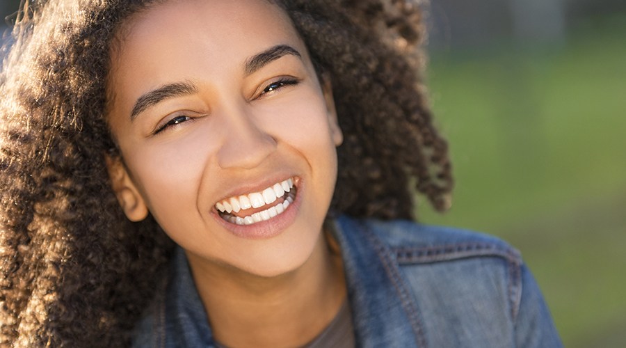 Teen girl sharing healthy smile after restorative dentistry
